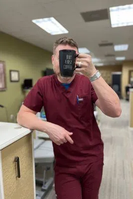 Dr. Matt Mackey Chiropractor Scubs holding coffee