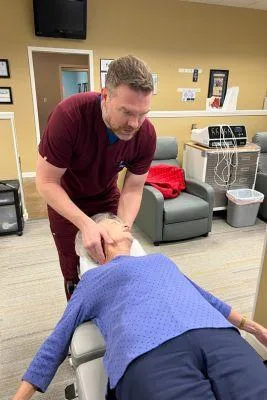 Dr. Matt Mackey Chiropractor treating patient 