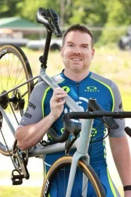 Dr. Matt Mackey Chiropractor holding bike