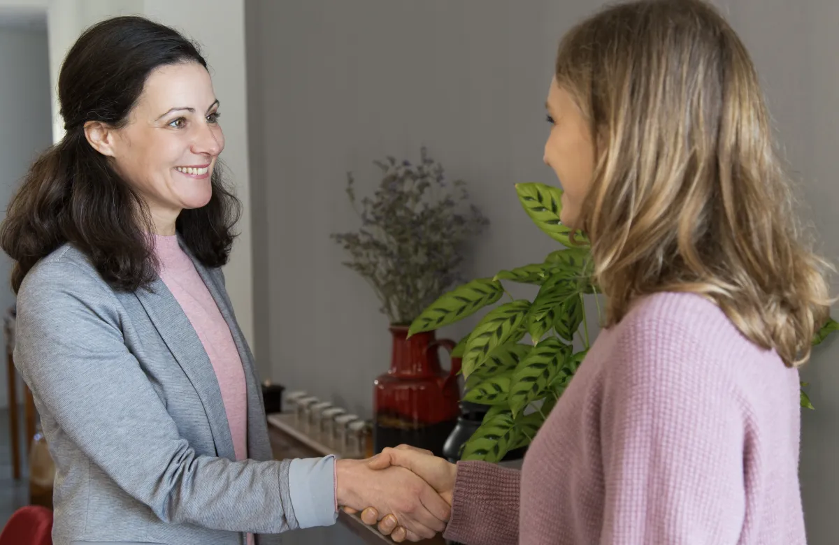 Two women shaking hands