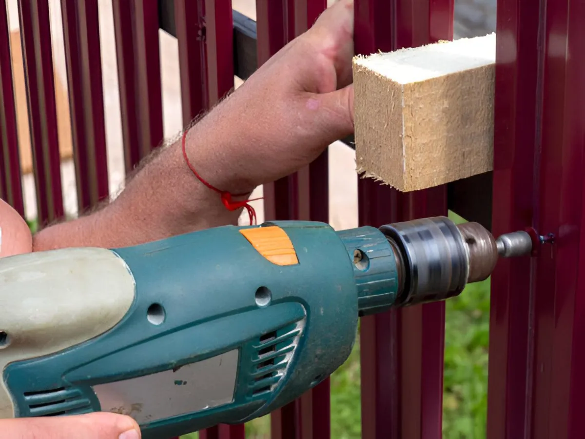 Technician performing professional fence repair Albany GA