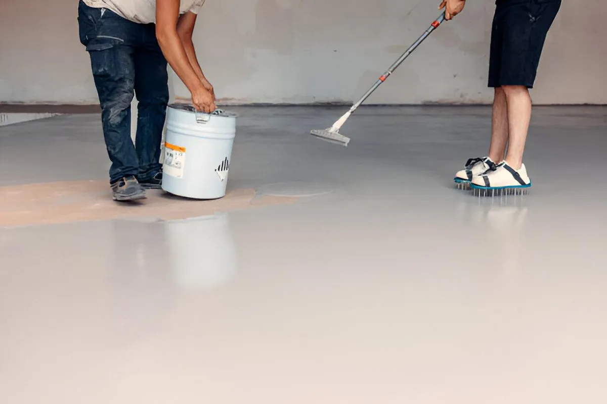 Skilled crew from a concrete driveway company near me laying fresh concrete