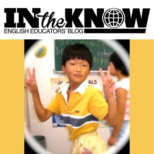 A young, happy boy in the classroom.