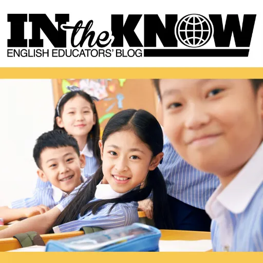 Happy students at their desks in an English Classroom.