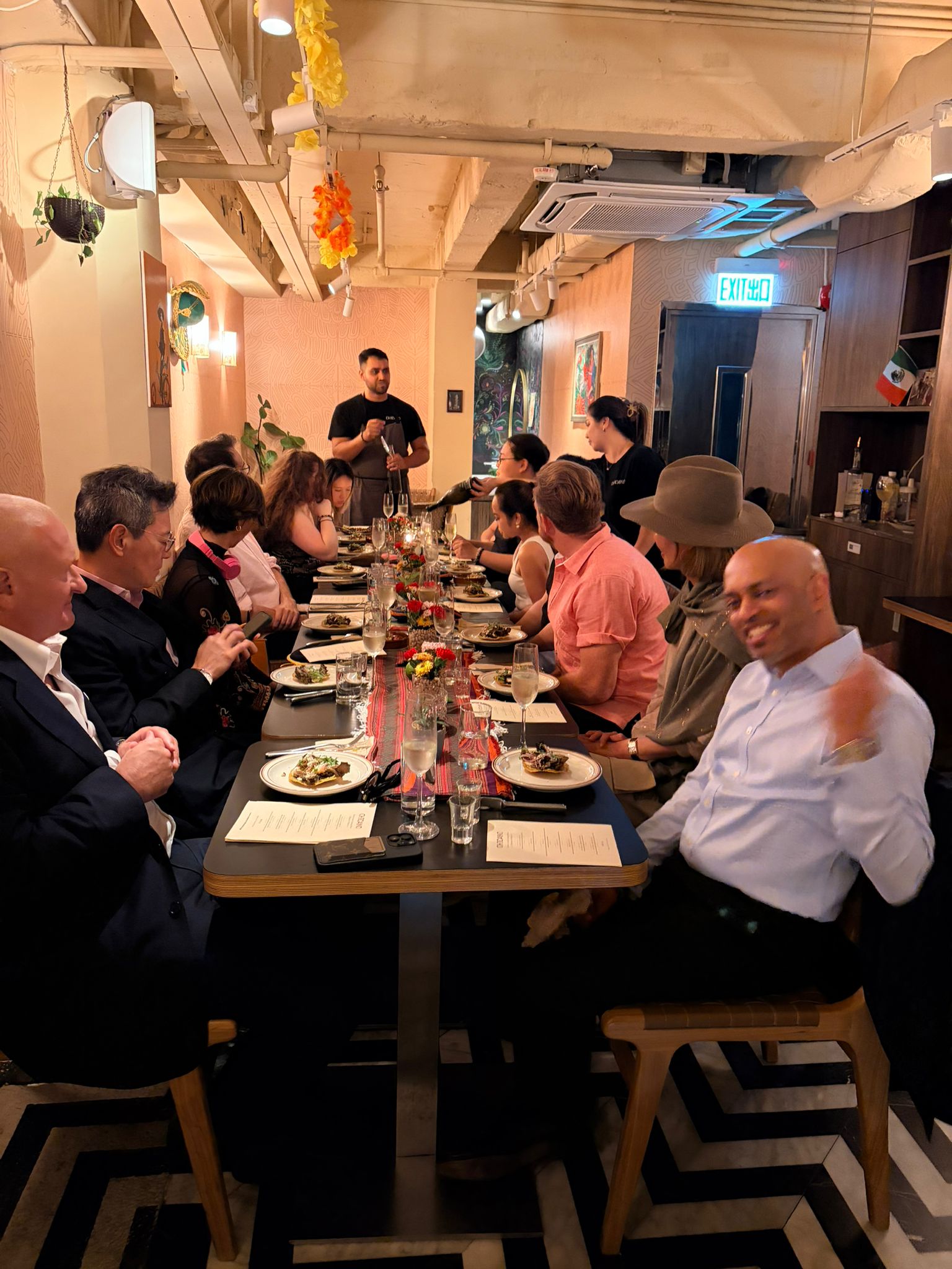 Corporate team enjoying a vibrant dinner celebration at Chicano