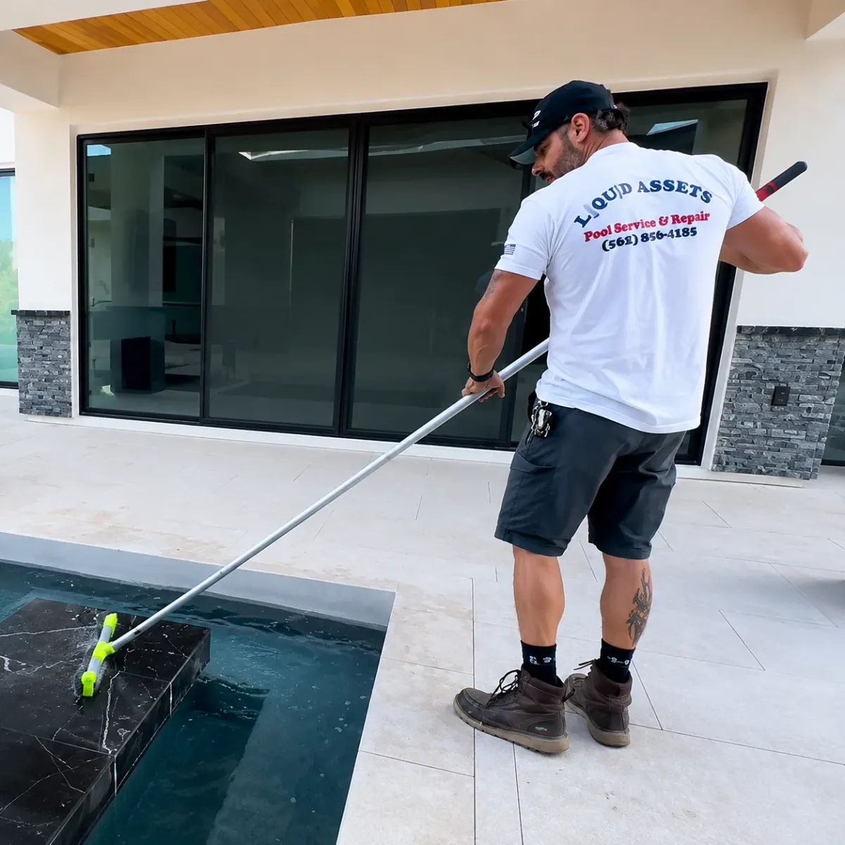 Pool technician performing routine pool cleaning