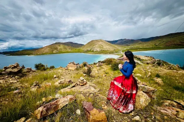 blue red and yellow textile on green grass field under white clouds during daytime