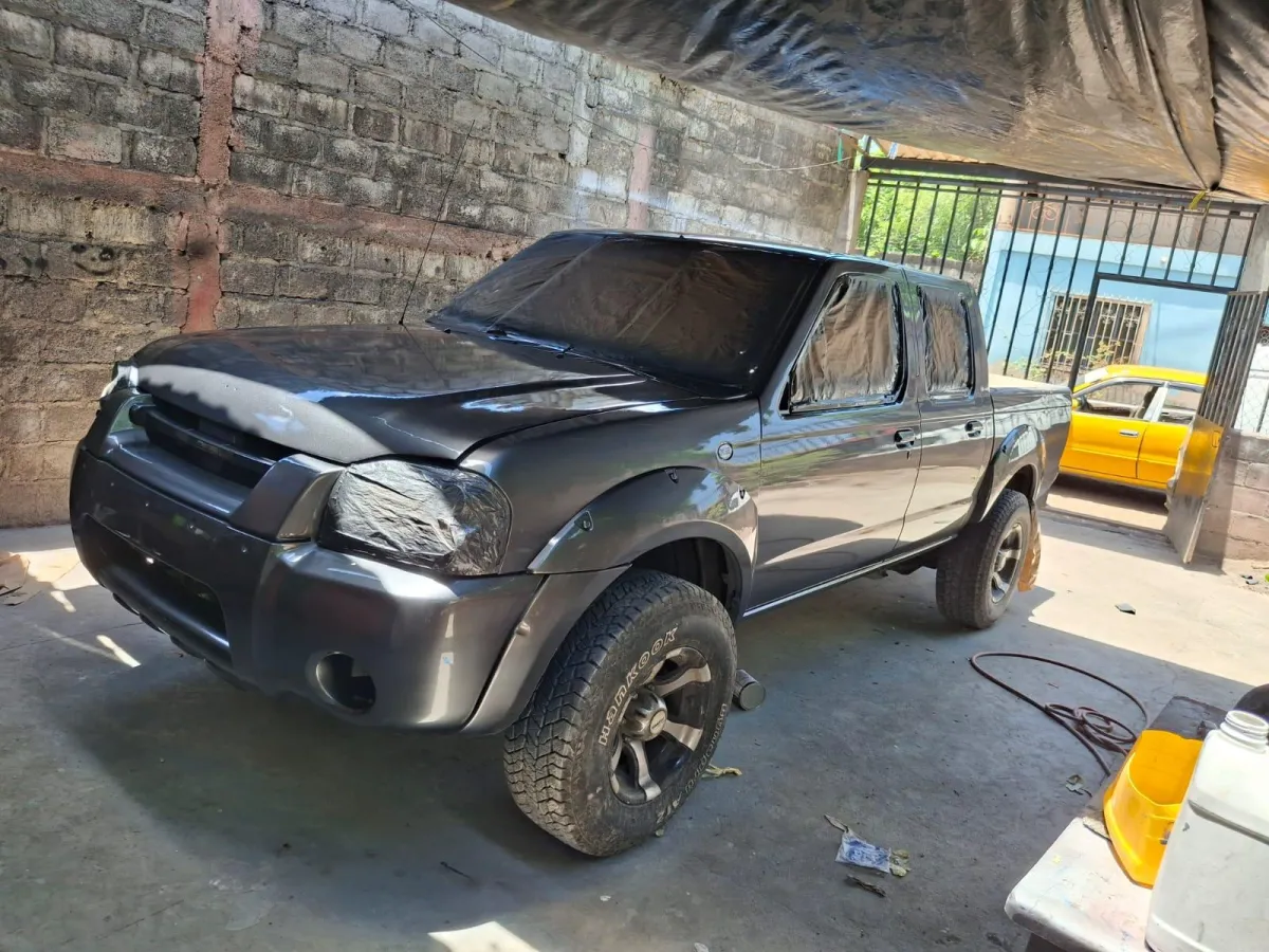 Digital multimeter displays zero in front of computer screen