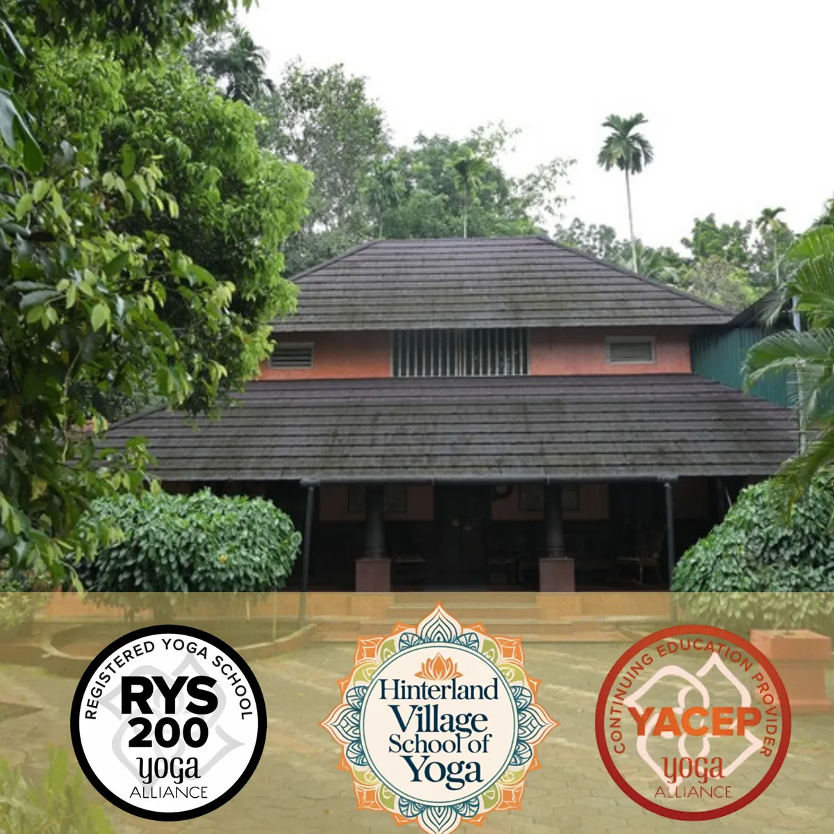 A traditional stone building with a tiled roof surrounded by green trees.