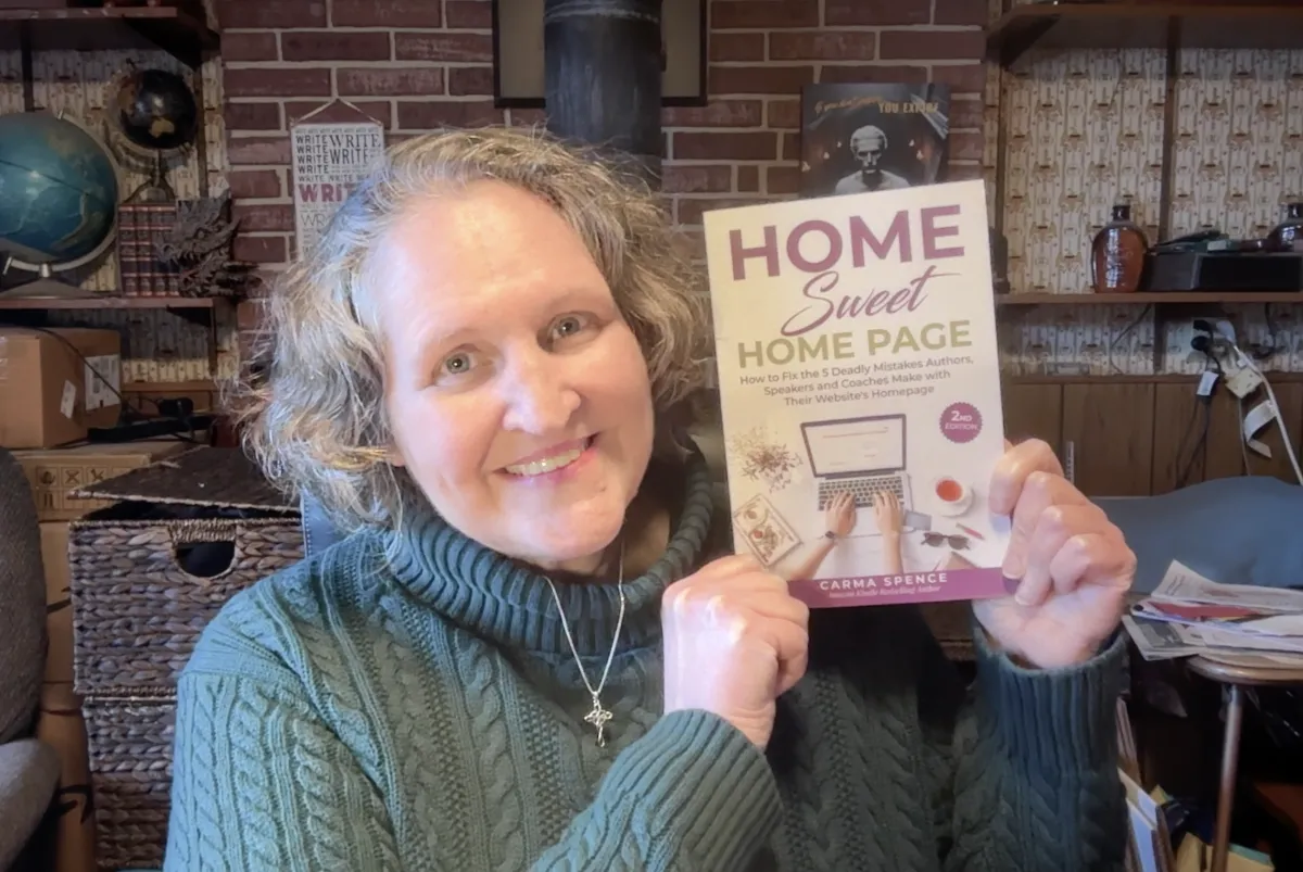 Carma holding a copy of Home Sweet Home Page, 2nd edition
