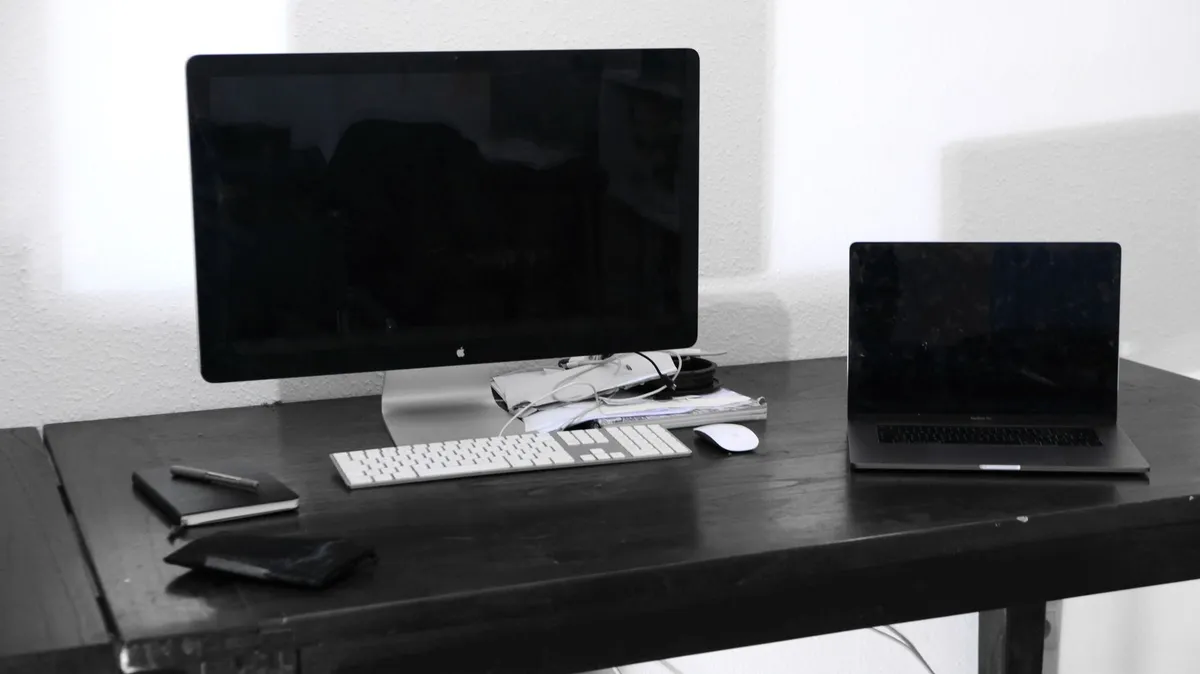 Desktop monitor and laptop on office desk illustrating business computer replacement planning