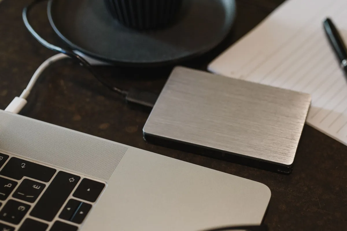 External hard drive connected to a laptop, highlighting cloud data backup and retrieval after service cancellation