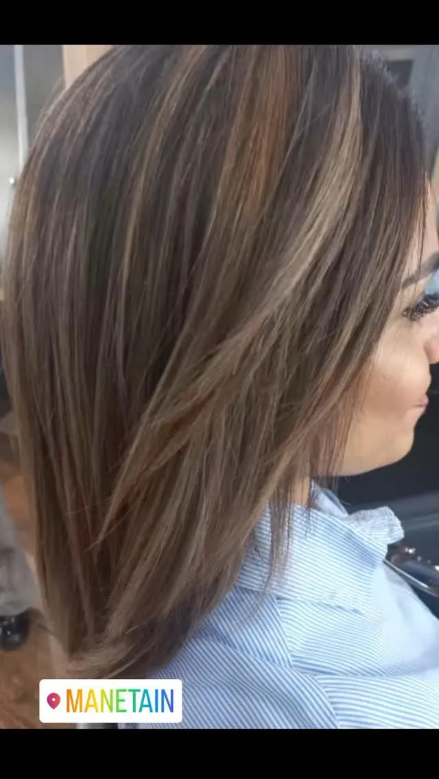 Wmand with flowing dark hair with streaks of blond
