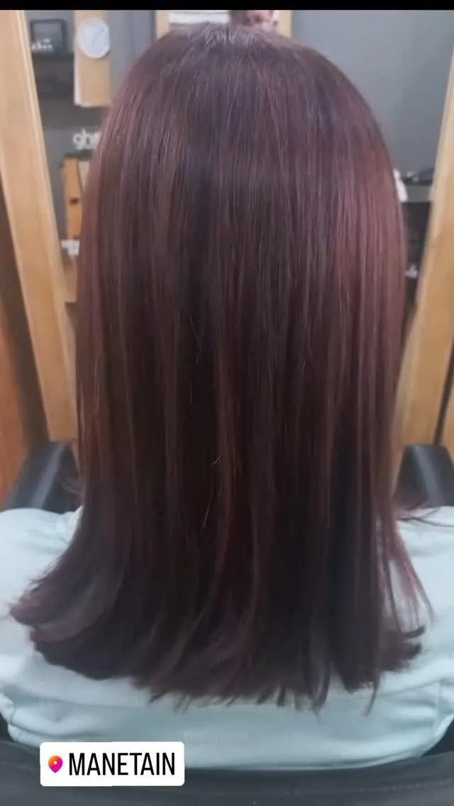Image a of the backside of a woman's head showing her newly blow dried hair