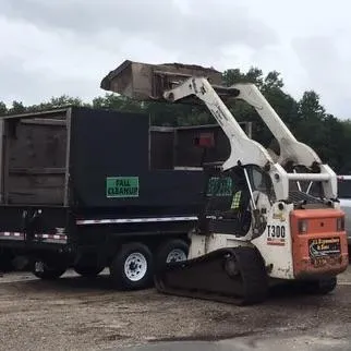 Leclerc & Son Lawn Care truck and equipment at a landscaping project