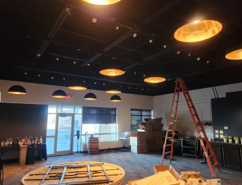 Small commercial kitchen with overhead conduit and service panels