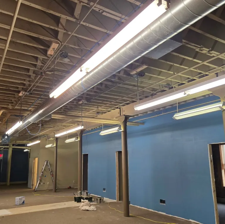 Technician installing an industrial control panel in a light-industrial plant