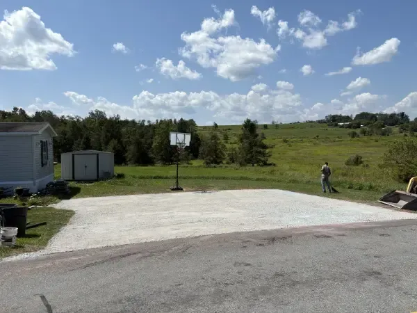 Gravel driveway installation and site preparation near rural home