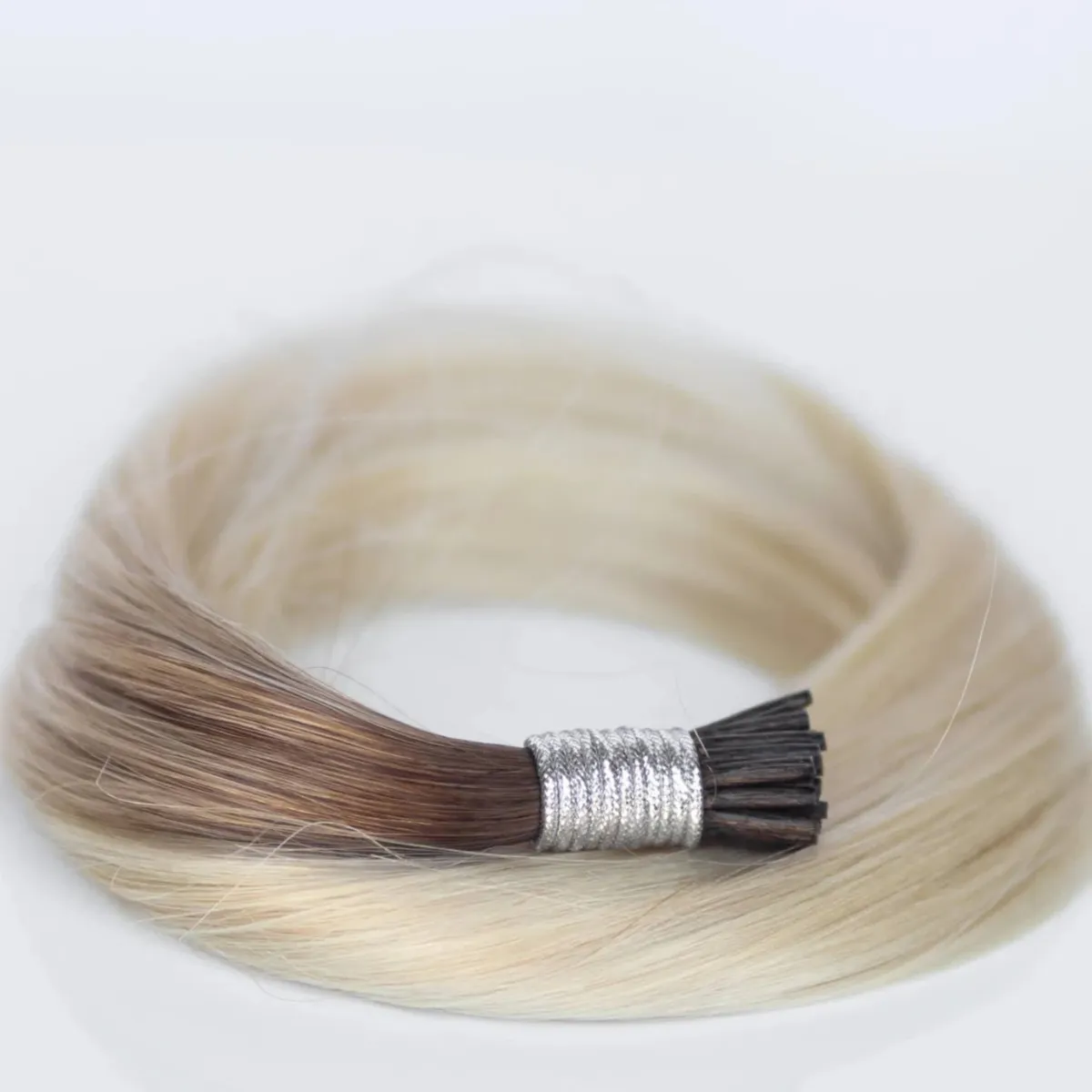 Close-up of I-Tip hair extensions secured with small micro beads for a heat-free, keratin-free installation