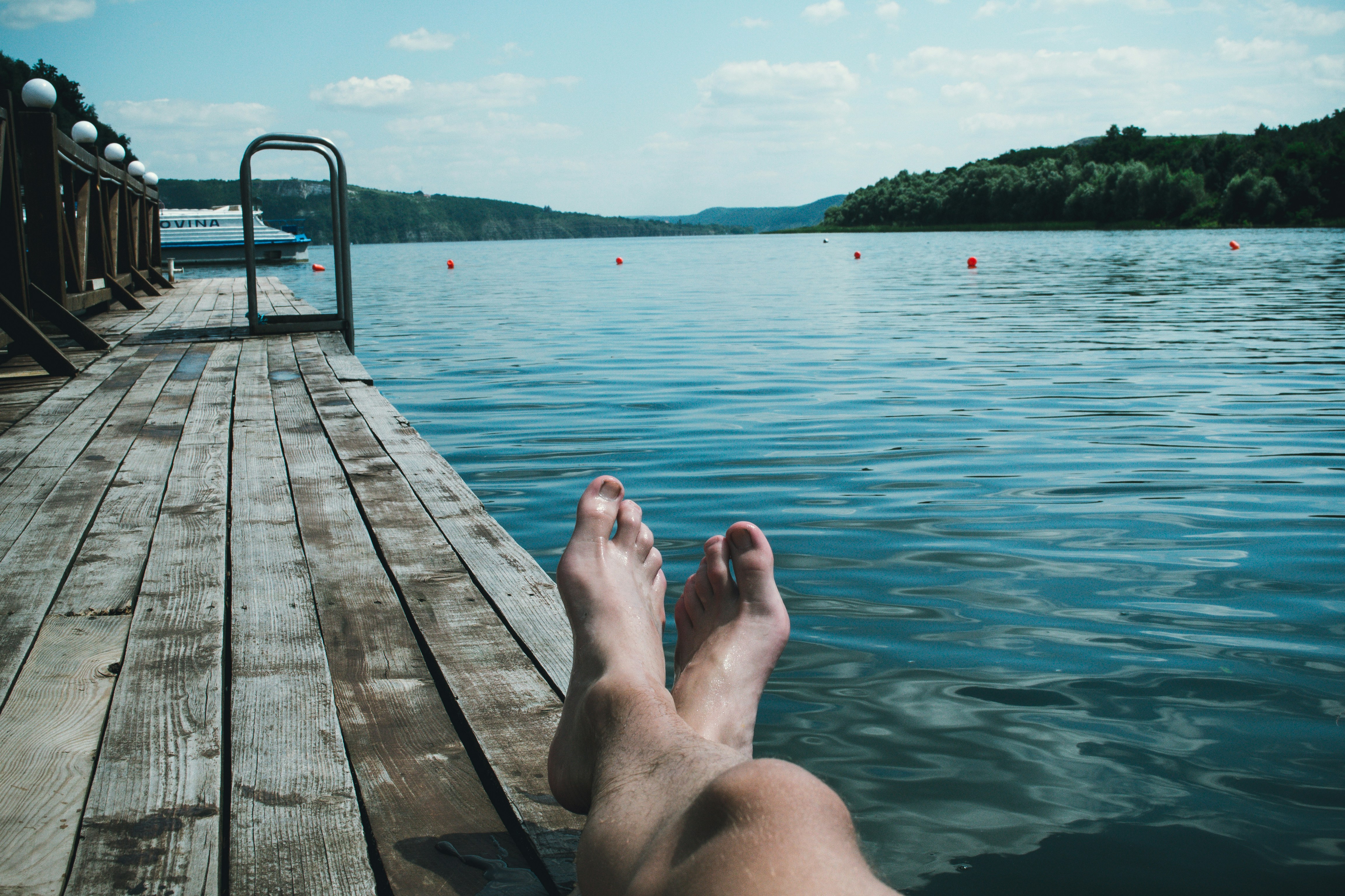Lounging an a dock and looking out at the water.