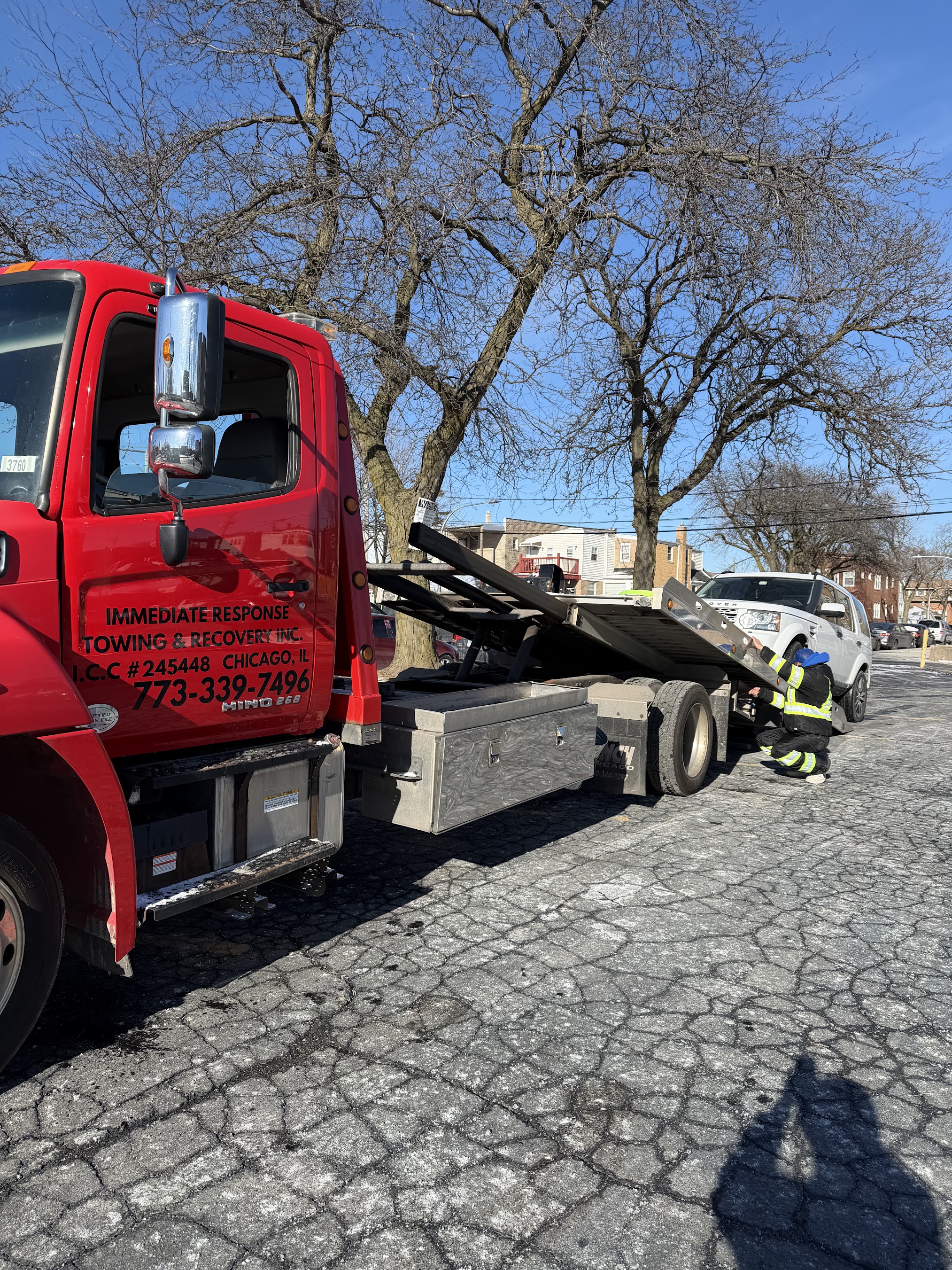 Car secured on a flat bed tow truck for damage-free towing