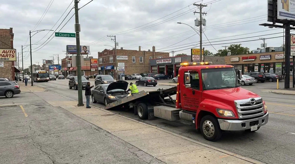 Cicero Avenue commercial corridor with tow truck responding to breakdown