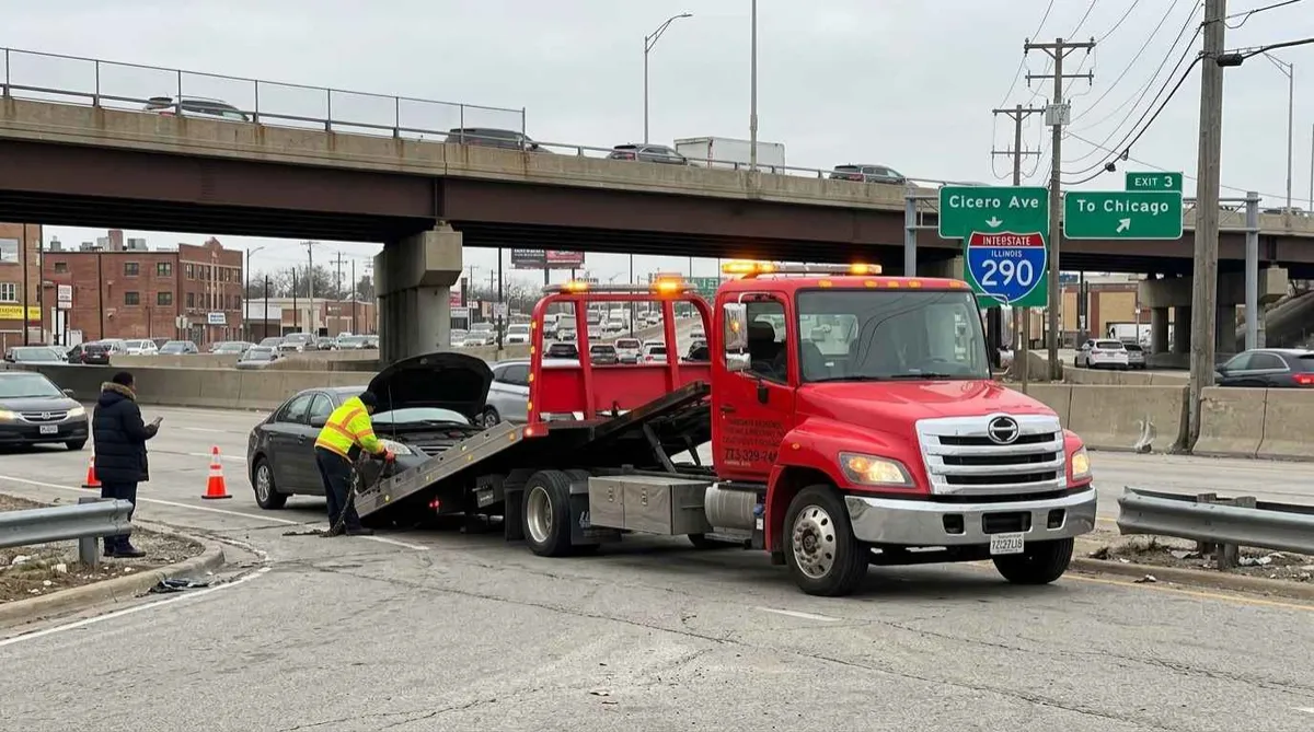 Emergency tow truck assisting a vehicle breakdown near Cicero Avenue and I-290 in Cicero, Illinois