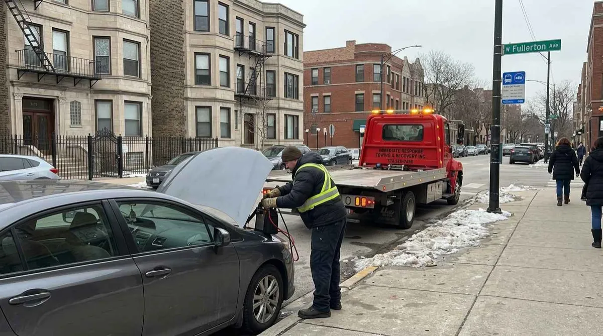 Technician performing battery jump-start on W Fullerton Avenue, Lincoln Park Chicago