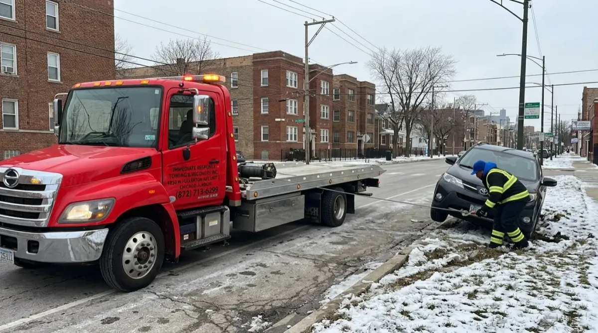 Tow truck performing Winch-Out Recovery Service for a stuck car