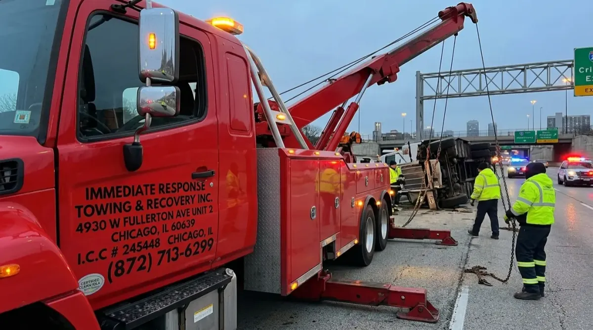 Tow truck recovering semi truck after accident on highway