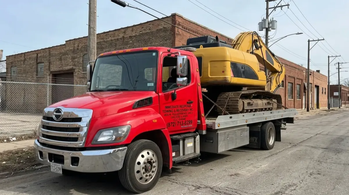 Tow truck transporting construction excavator- Heavy Equipment