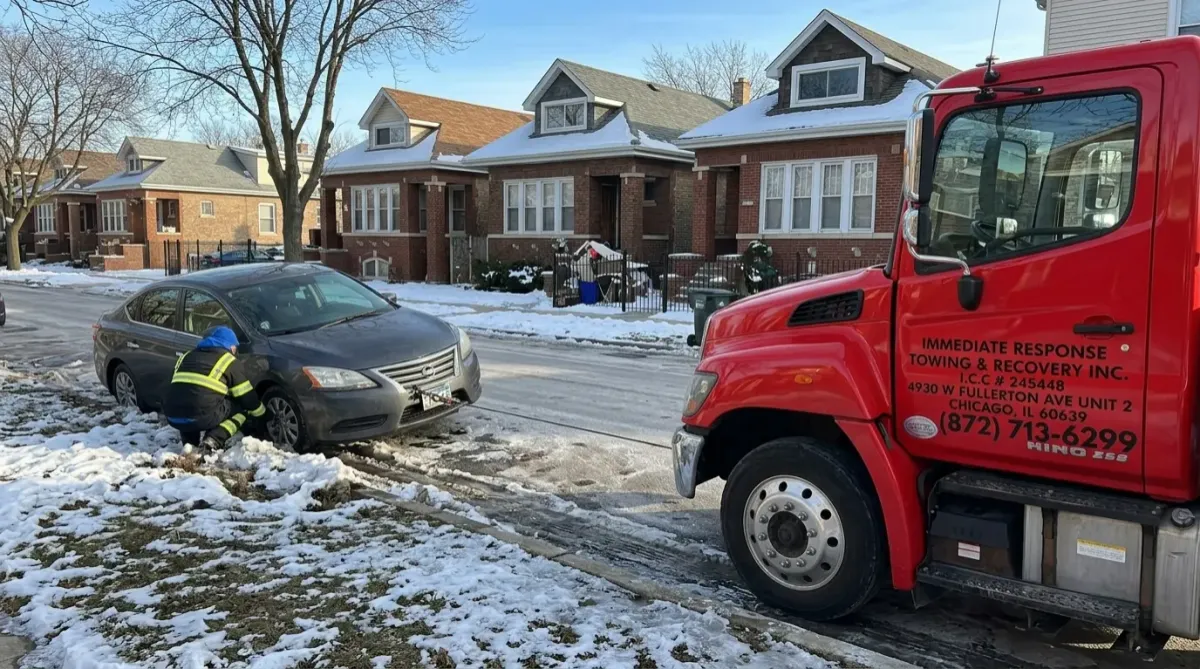 Tow truck performing winch recovery service in Portage Park