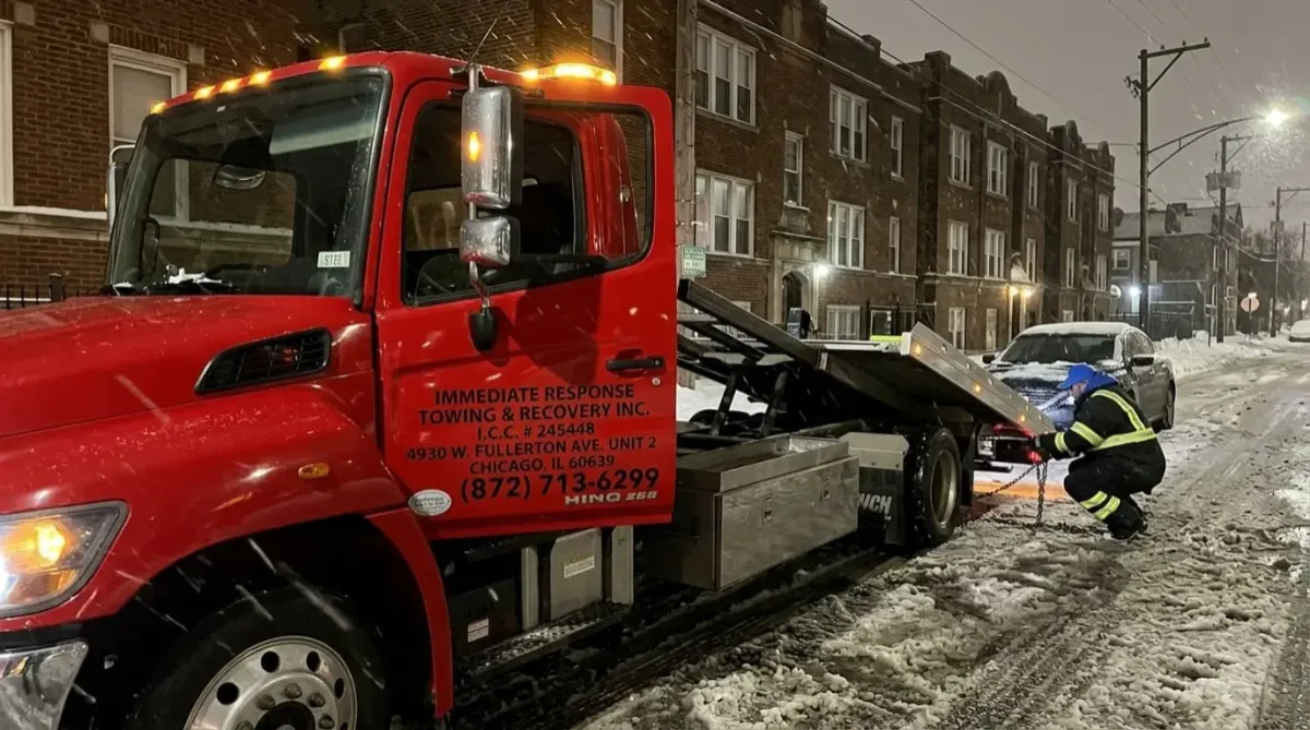 Tow truck responding to emergency breakdown due to winter weather