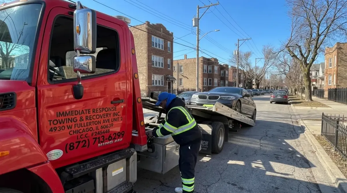 Flatbed tow truck loading a passenger car