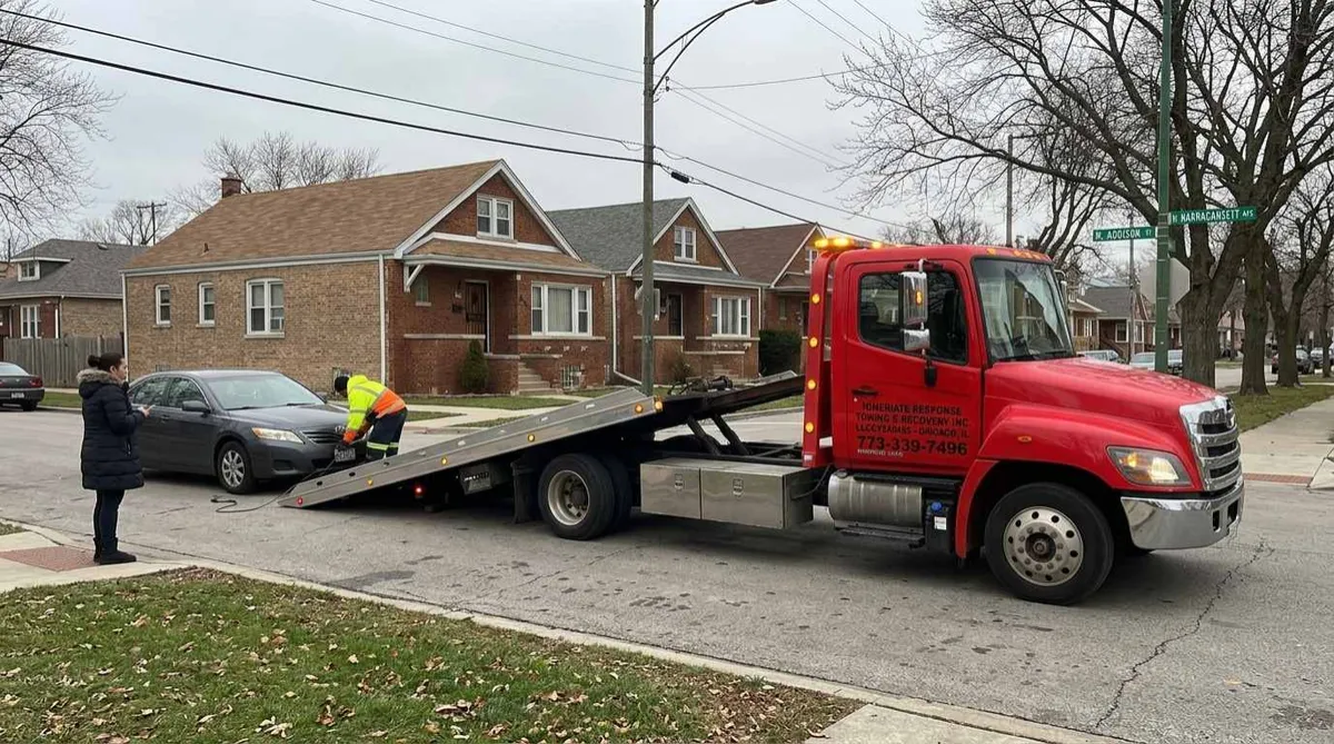 Tow truck towing Light duty car in dunning chicago street