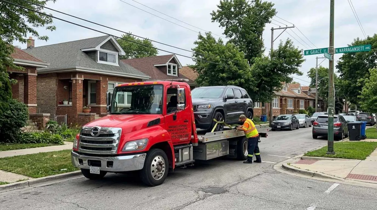 Flatbed tow truck loading a disabled car in Dunning, Chicago