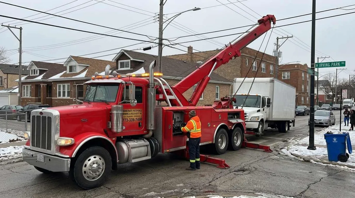 Heavy-duty wrecker recovering a disabled commercial truck in Dunning, Chicago