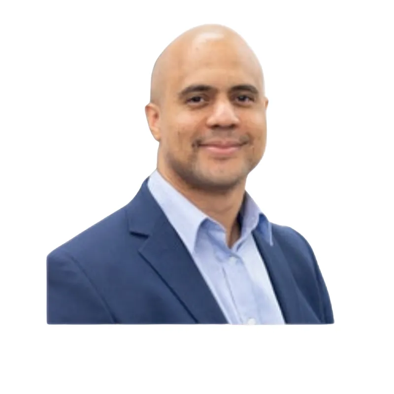 Three-quarter portrait of Voight Thornton on location, wearing denim jacket, leaning slightly forward, warm golden-hour rim light, urban brick alley softly blurred behind, cinematic color grade, confident approachable expression, professional photographer setup.