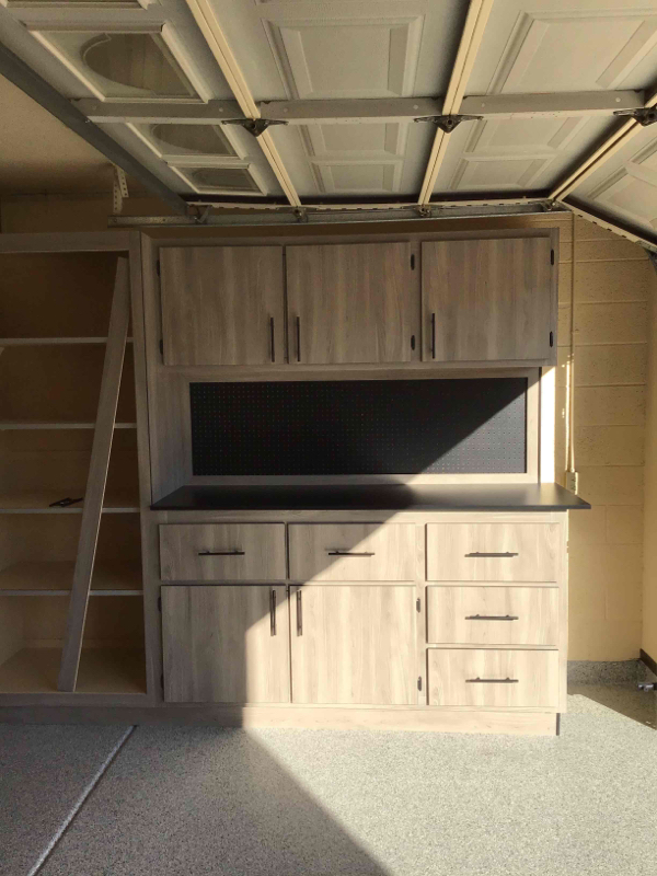 Freshly coated epoxy garage floor reflecting sunlight inside an empty single-car garage.