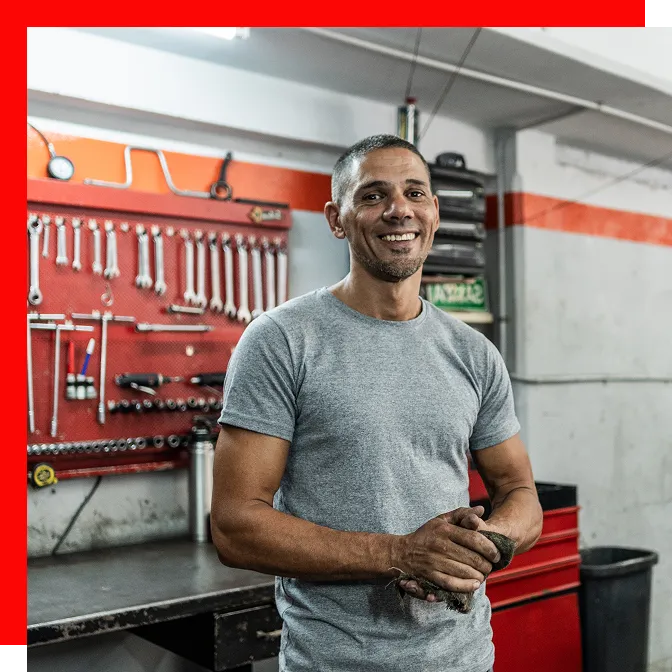 Professional installer rolling out an epoxy coating across a commercial concrete floor during application.