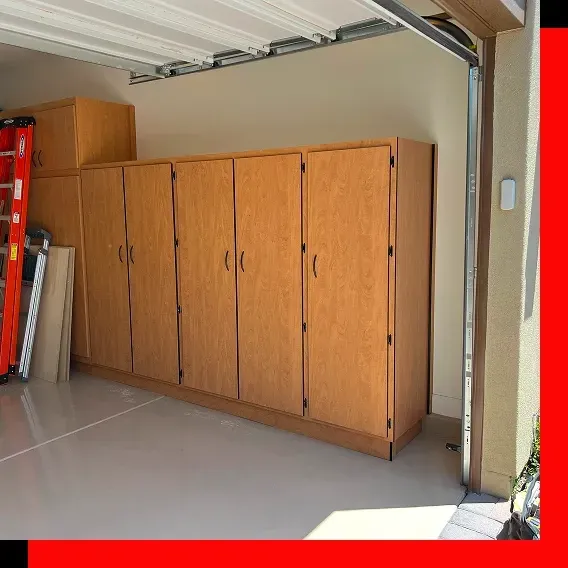 Professional installer broadcasting decorative flakes during an epoxy floor coating inside a commercial space.