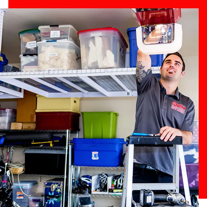 Professional installer rolling out an epoxy coating across a commercial concrete floor during application.
