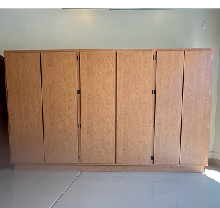 Professional installer broadcasting decorative flakes during an epoxy floor coating inside a commercial space.