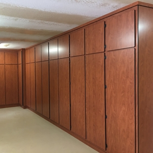 The cabinets are a reddish-brown wood tone with dark, slender handles