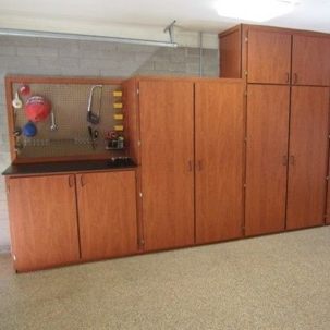 wooden-toned cabinets and a pegboard
