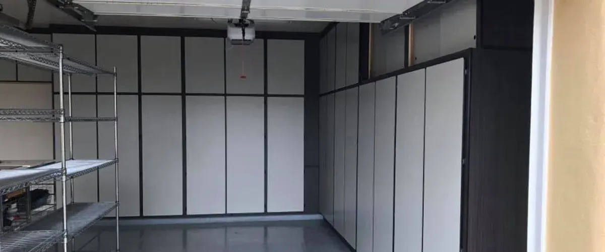 Custom garage cabinet system with workbench, pegboard wall, and multiple storage drawers