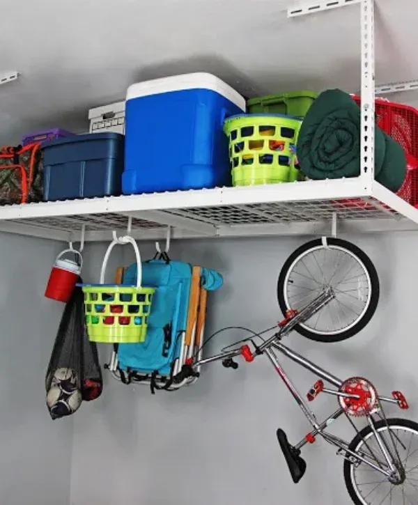 Garage ceiling storage rack holding bins, cooler, and bike for overhead organization