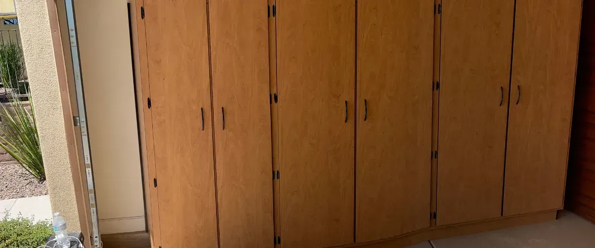 Custom garage cabinet system with workbench, pegboard wall, and multiple storage drawers
