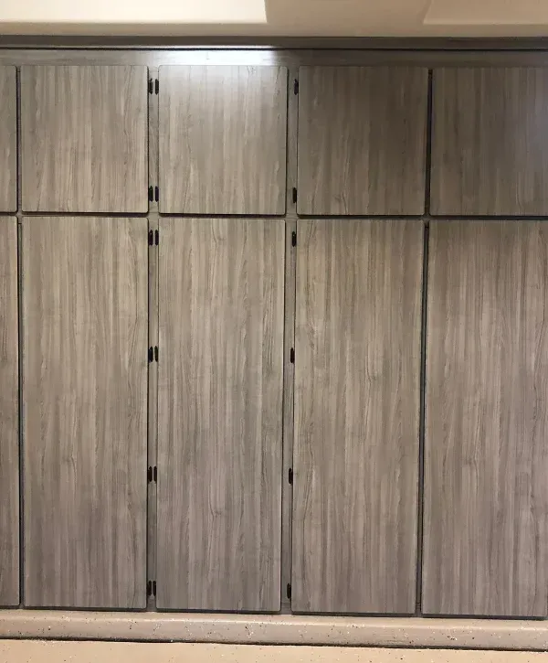 Gray garage storage cabinet wall with tall doors and upper cabinets for clean garage look