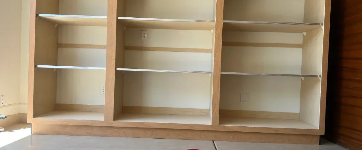 Custom garage cabinet system with workbench, pegboard wall, and multiple storage drawers